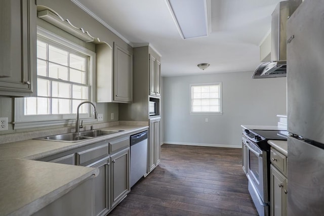 2205 Briarcliff Dr, Valdosta, GA 31602 - kitchen featuring a sink, wall chimney range hood, appliances with stainless steel finishes, light countertops, and dark wood-style flooring
