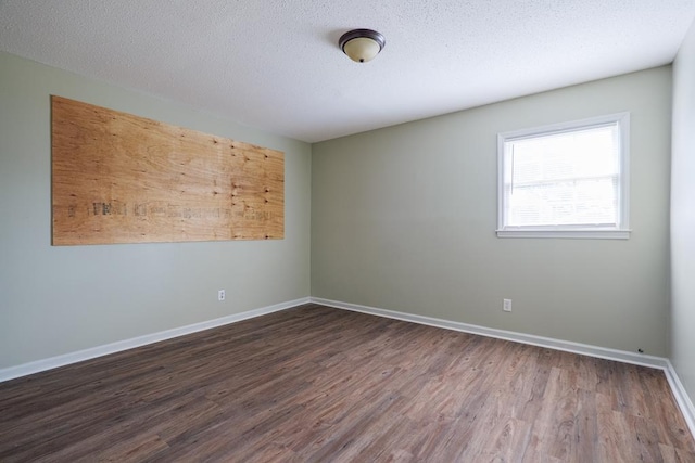 2205 Briarcliff Dr, Valdosta, GA 31602 - empty room featuring a textured ceiling, baseboards, and wood finished floors