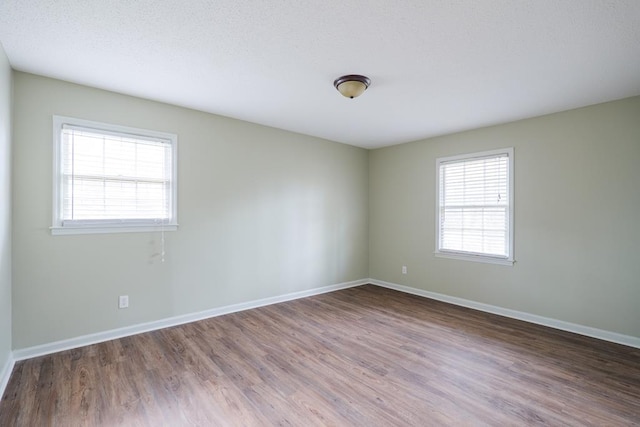 2205 Briarcliff Dr, Valdosta, GA 31602 - empty room featuring baseboards, a textured ceiling, and wood finished floors
