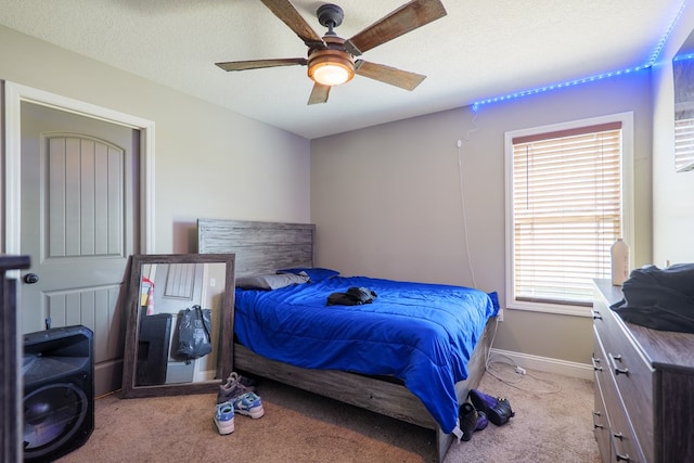 3908 Crusader Ct, Valdosta, GA 31605 - bedroom featuring light carpet, baseboards, ceiling fan, and a textured ceiling