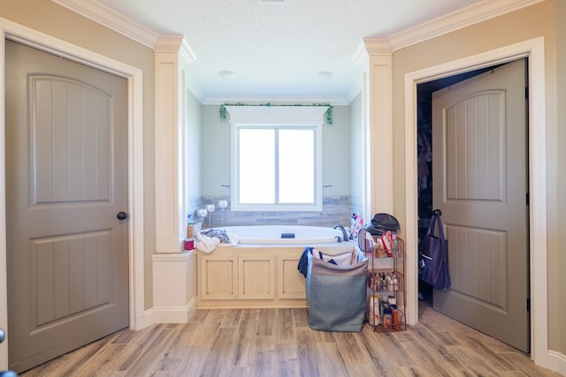 3908 Crusader Ct, Valdosta, GA 31605 - full bathroom featuring a bath, wood finished floors, ornamental molding, and a textured ceiling