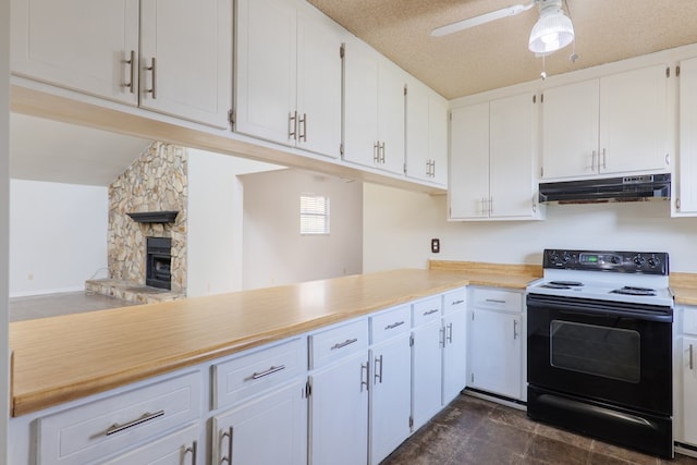 kitchen featuring a wood stove, white cabinets, black electric range, a textured ceiling, and kitchen peninsula