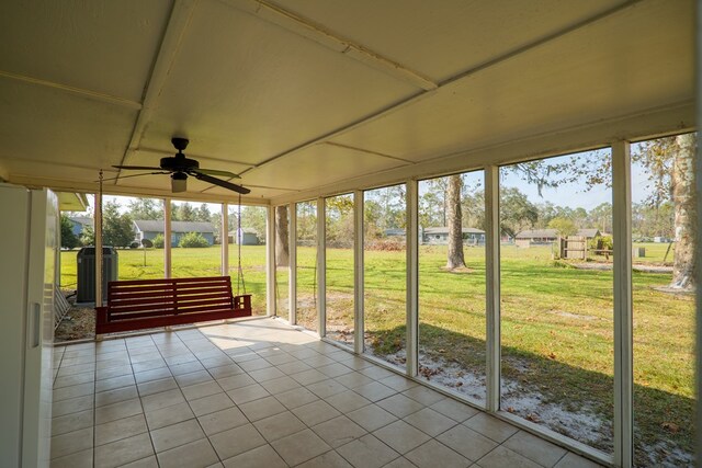 unfurnished sunroom with ceiling fan