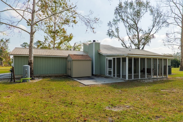 rear view of house featuring a lawn