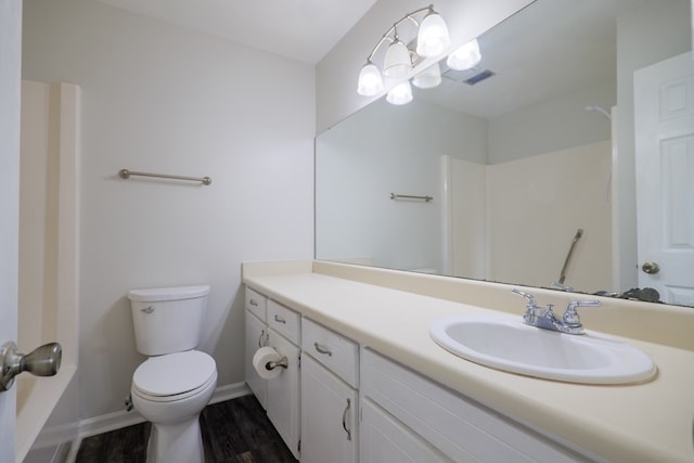 bathroom featuring vanity, wood-type flooring, and toilet