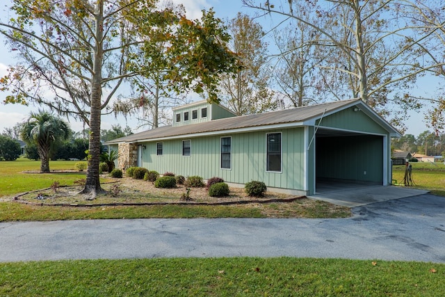 view of property exterior with a carport and a yard