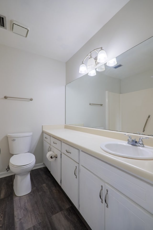 bathroom with hardwood / wood-style floors, vanity, and toilet