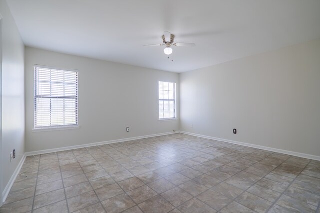 spare room with ceiling fan and a healthy amount of sunlight