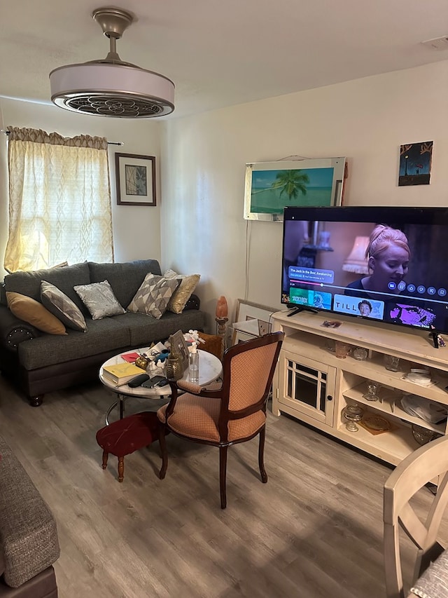 living room featuring visible vents and wood finished floors