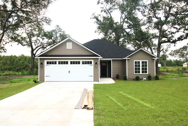 view of front facade with concrete driveway, a front yard, a shingled roof, and an attached garage