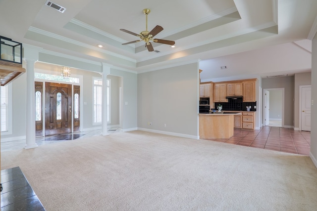 3532 Victoria Dr, Valdosta, GA 31602 - unfurnished living room featuring decorative columns, a raised ceiling, light colored carpet, ceiling fan, and crown molding