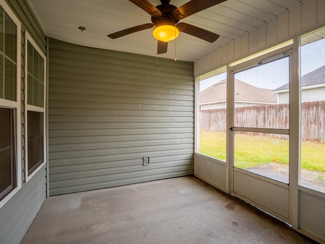 unfurnished sunroom with a ceiling fan