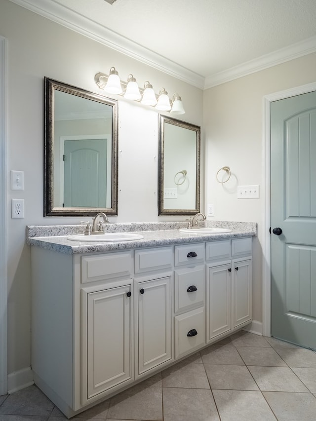 bathroom featuring double vanity, tile patterned flooring, crown molding, and a sink