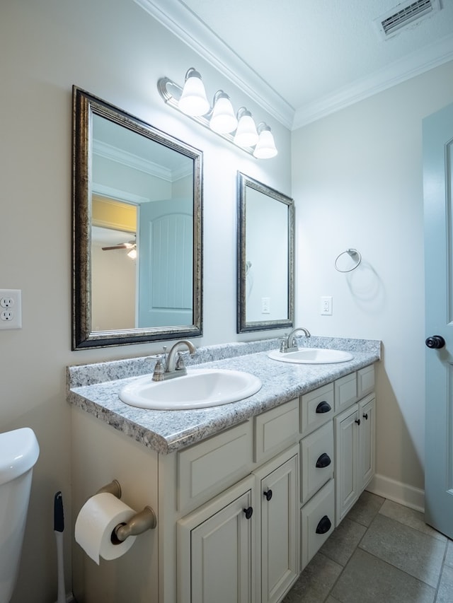 bathroom featuring ornamental molding, visible vents, a sink, and double vanity