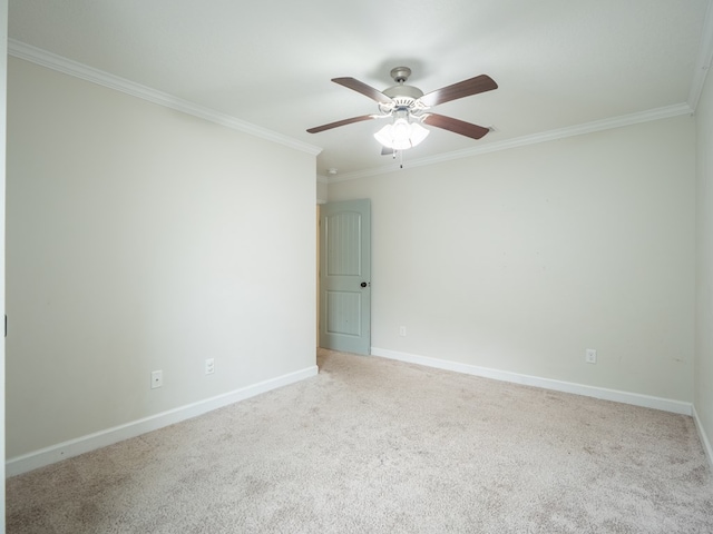 unfurnished room with carpet floors, crown molding, baseboards, and a ceiling fan