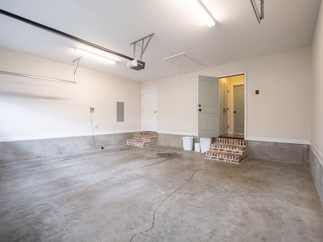 garage with electric panel and a garage door opener