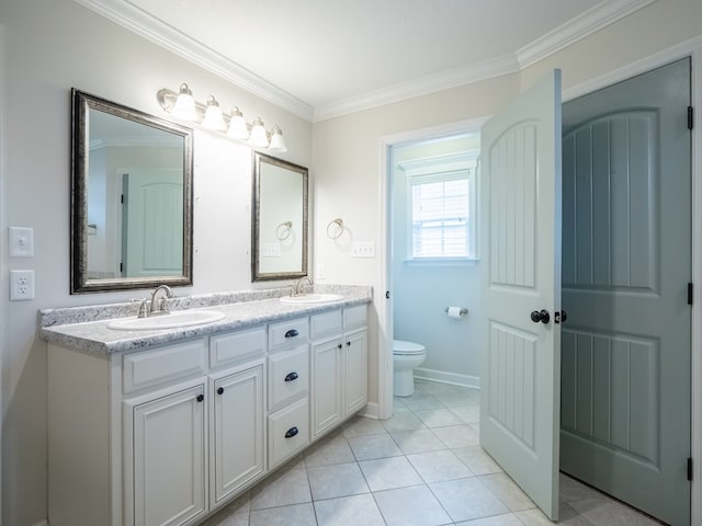 full bathroom featuring double vanity, toilet, ornamental molding, a sink, and tile patterned flooring