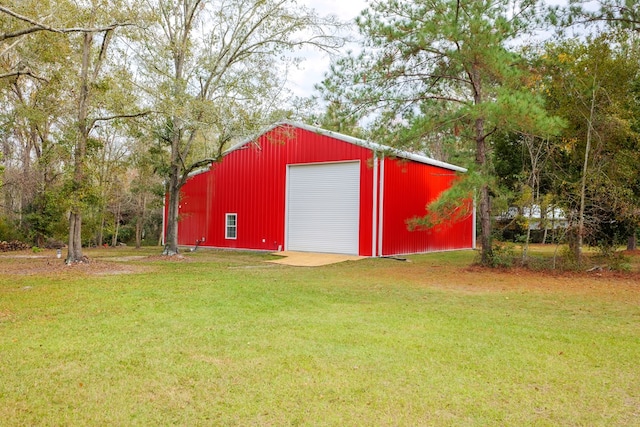 view of outbuilding featuring a garage and a lawn