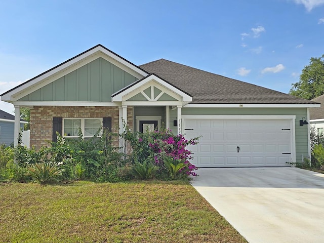 5175 Grand Oak Cir, Lake Park, GA 31636 - view of front of house with board and batten siding, concrete driveway, a front yard, a garage, and roof with shingles