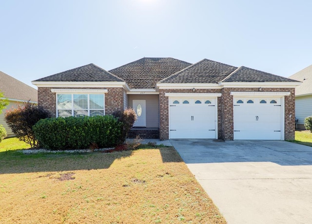 ranch-style home featuring a garage and a front yard