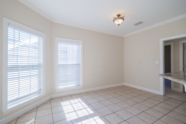 unfurnished room featuring crown molding and light tile patterned floors