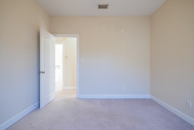 unfurnished room with light colored carpet