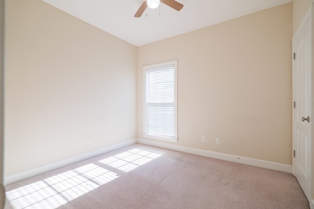 spare room with light carpet and ceiling fan