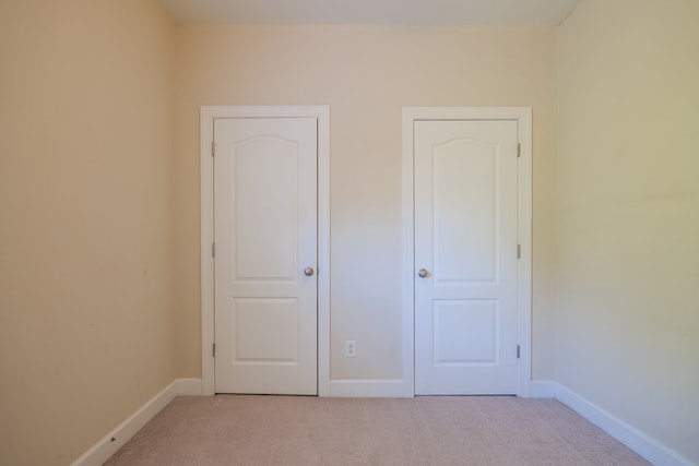 unfurnished bedroom with light carpet