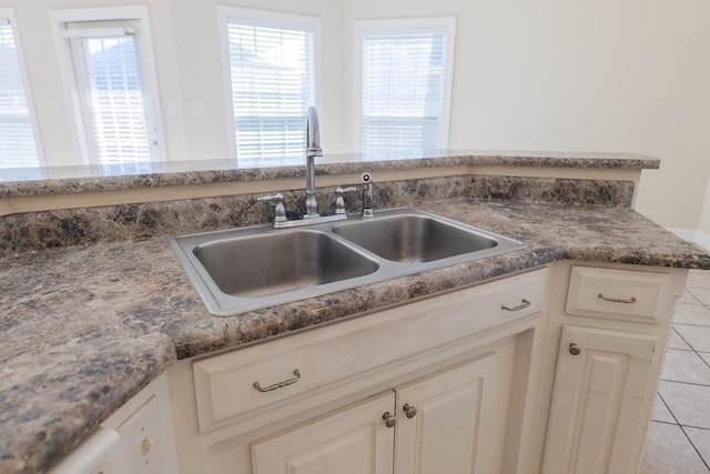 kitchen featuring light tile patterned flooring and sink