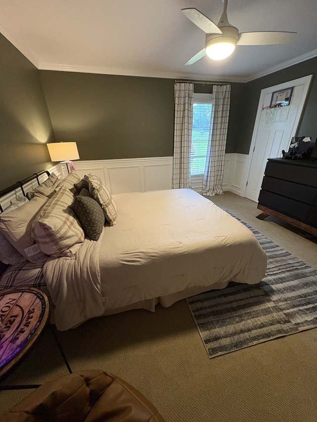 2406 Winding Way, Valdosta, GA 31602 - bedroom featuring ornamental molding, a decorative wall, a wainscoted wall, a ceiling fan, and carpet