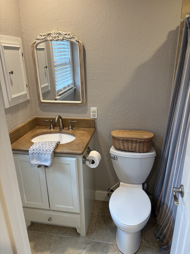 2406 Winding Way, Valdosta, GA 31602 - bathroom with vanity, tile patterned flooring, and a textured wall