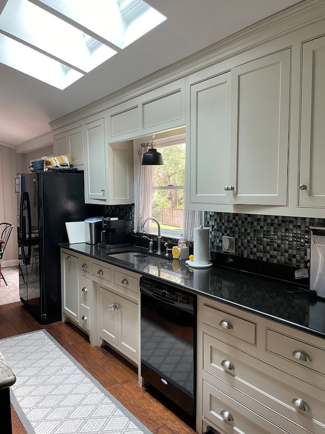 2406 Winding Way, Valdosta, GA 31602 - kitchen featuring black appliances, a skylight, decorative backsplash, and dark wood finished floors