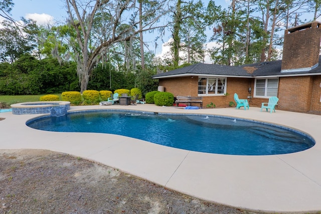 view of swimming pool featuring a pool with connected hot tub and a patio area