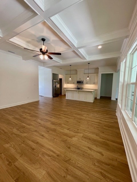 unfurnished living room featuring dark wood-style floors, coffered ceiling, and a ceiling fan