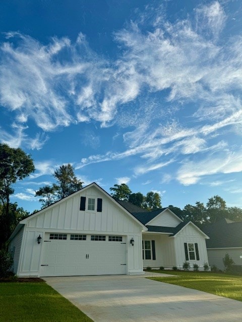 view of front of home featuring a garage, a front lawn, board and batten siding, and concrete driveway