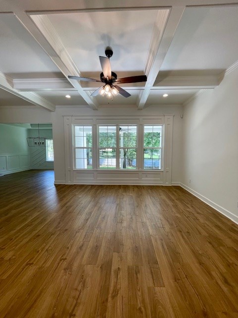 spare room featuring ceiling fan, wood finished floors, coffered ceiling, beamed ceiling, and baseboards