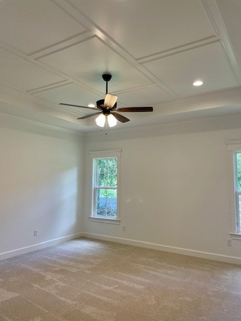 empty room with a ceiling fan, a wealth of natural light, light colored carpet, and baseboards