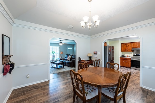 dining room with arched walkways, baseboards, wood finished floors, and visible vents