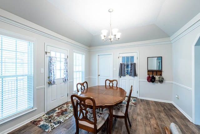 dining space featuring an inviting chandelier, dark wood-style floors, and lofted ceiling