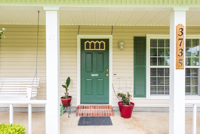view of exterior entry with a porch