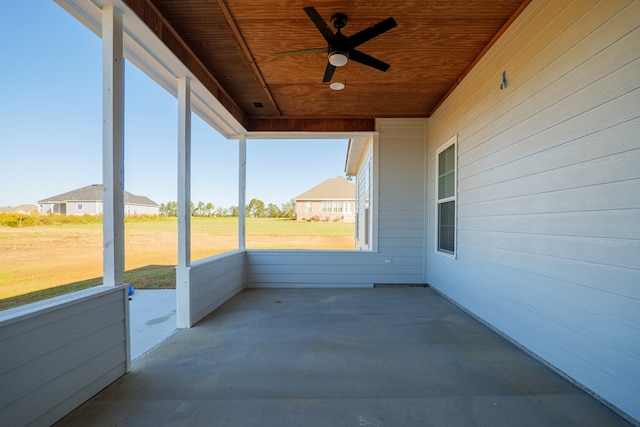 unfurnished sunroom featuring ceiling fan and wooden ceiling