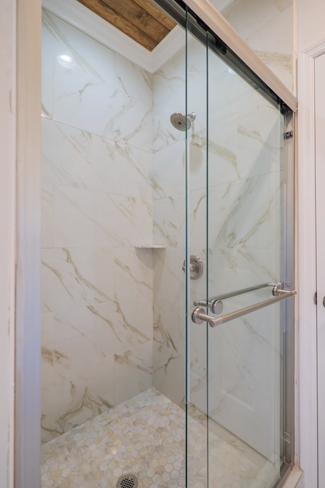 bathroom featuring a shower with shower door