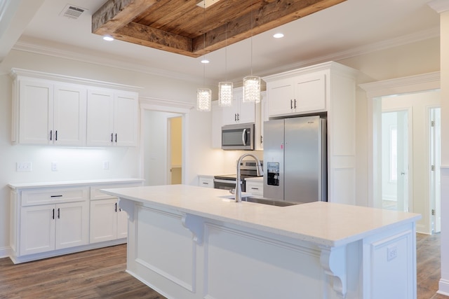 kitchen with white cabinetry, stainless steel appliances, a raised ceiling, dark hardwood / wood-style flooring, and a kitchen island with sink