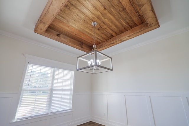 interior space featuring dark hardwood / wood-style floors, an inviting chandelier, and ornamental molding