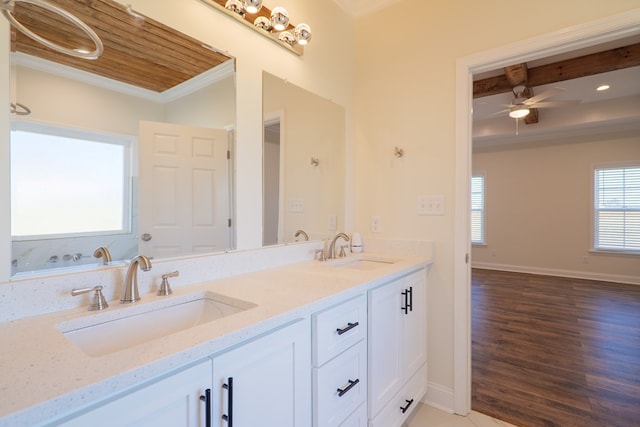 bathroom with ceiling fan, hardwood / wood-style floors, vanity, and crown molding