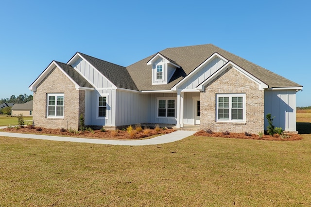 craftsman inspired home with a front lawn