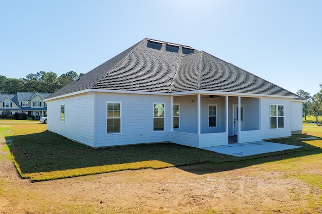 back of property featuring a patio area and a yard