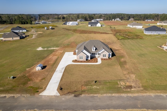 birds eye view of property with a rural view