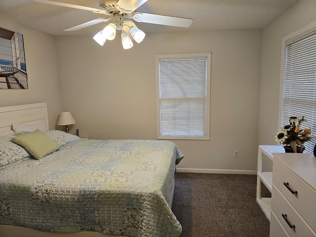 bedroom with dark colored carpet, a textured ceiling, and ceiling fan