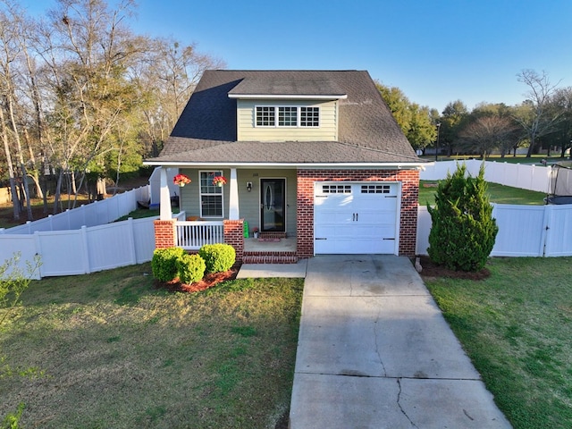 view of front of property featuring a front yard, fence, driveway, a porch, and brick siding